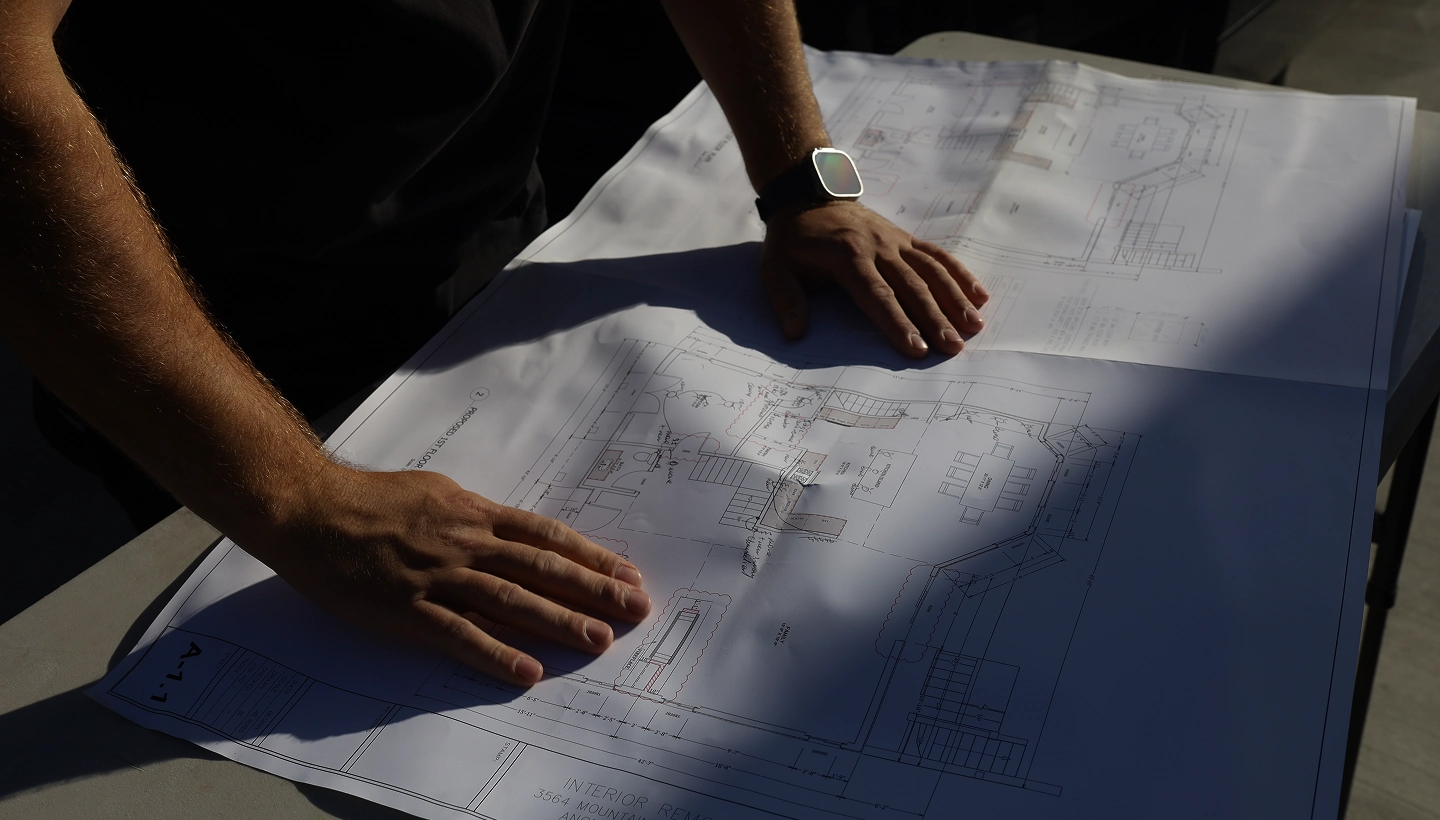ProMates Electric electrician reviewing construction blueprints for an electrical project in Los Angeles
