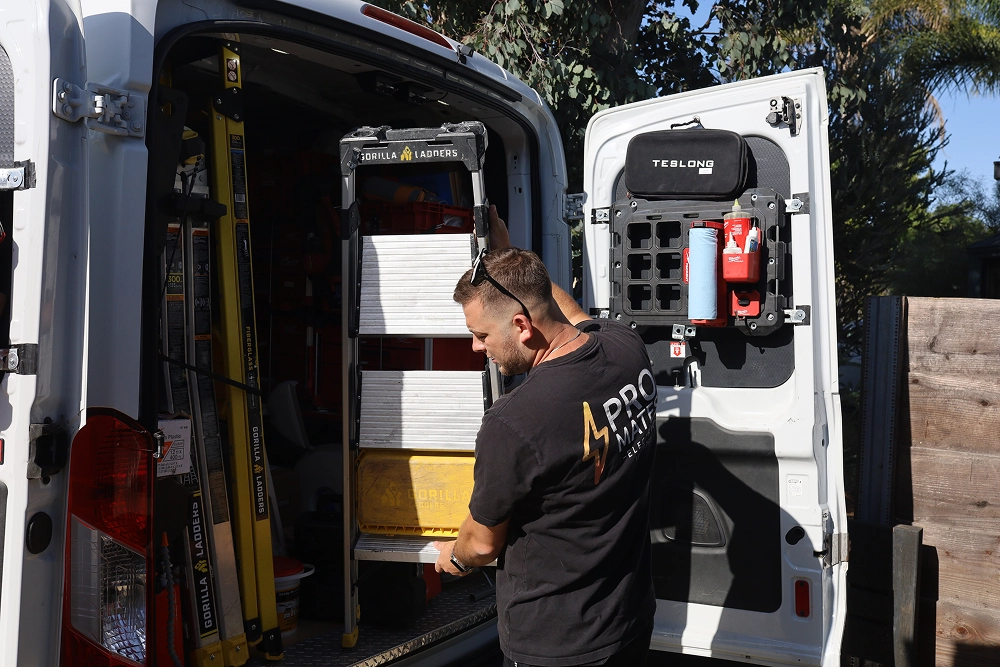 ProMates Electric electrician preparing service equipment from a work van in Los Angeles